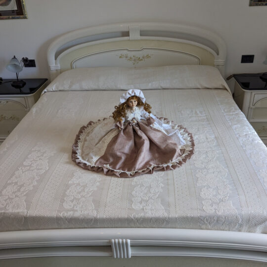 Bambola da letto modello "Diana" adagiata sul letto matrimoniale. Vista frontale.